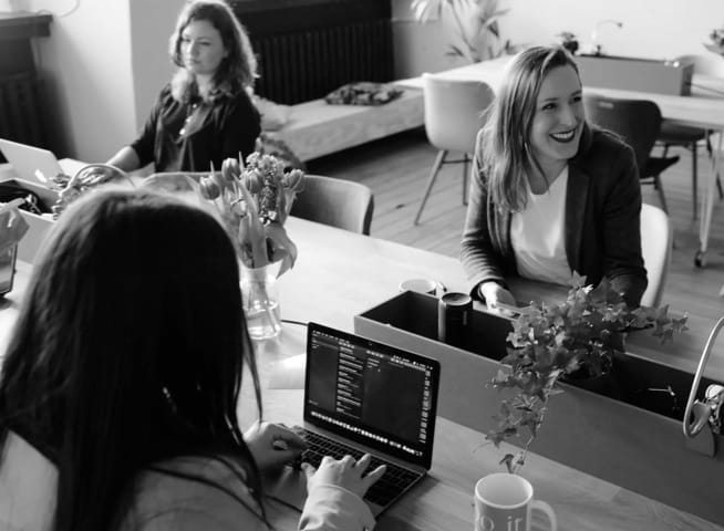 three girls at an office table